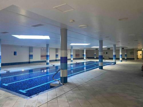 an empty swimming pool in a large building at Apartment in Chiswick with Pool, sauna & Gym in Sydney