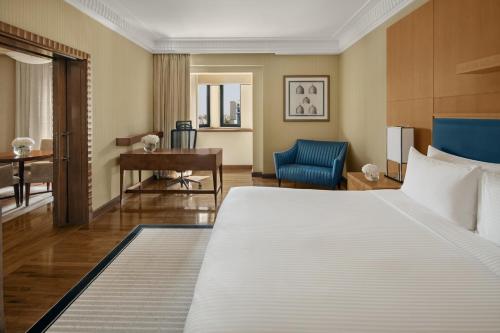 a hotel room with a large bed and a desk at InterContinental Riyadh, an IHG Hotel in Riyadh