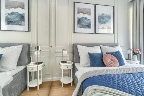 a bedroom with a bed and a couch and two tables at HO!HOUSE SHELLTER ROGOWO in Rogowo