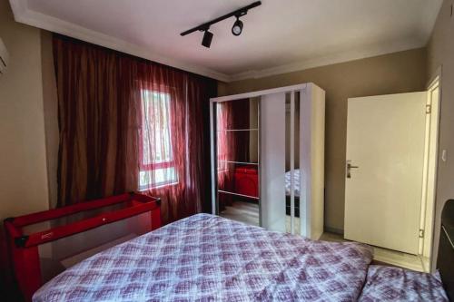 a bedroom with a bed and a window at "Kale Street" Alanya in Alanya