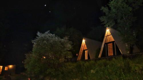 a house with lights on the roof at night at Beyond Stay Arnahyam Resort Sattal in Bhīm Tāl