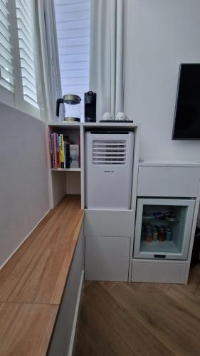 a kitchen with an oven and a book shelf at LIEV Amsterdam Cozy boutique suite in The Pijp in Amsterdam