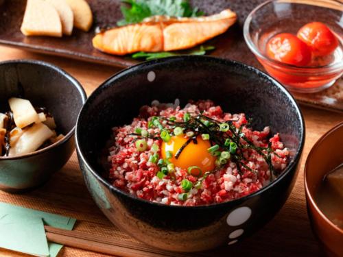 Un tazón de comida con un huevo dentro sobre una mesa. en Tokachi Nakasatsunai Glamping Resort Feriendorf, en Naka-satsunai