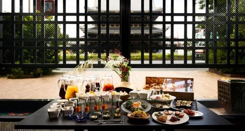 a table with plates of food on top of it at Hotel Kuu Kyoto in Kyoto