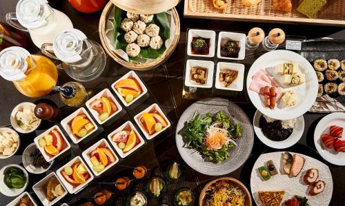 a table with many plates of food and drinks at Hotel Kuu Kyoto in Kyoto
