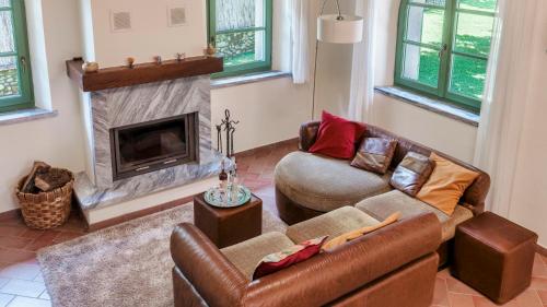 a living room with two couches and a fireplace at Villa Elsa 6, Emma Villas in Filetto
