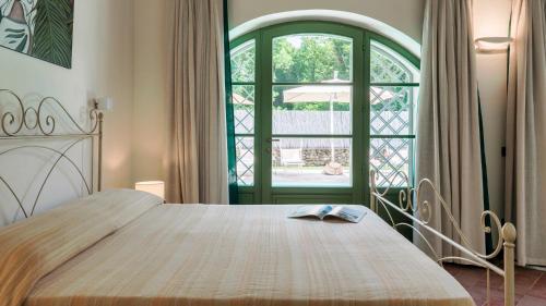 a bedroom with a bed and a large window at Villa Elsa 6, Emma Villas in Filetto