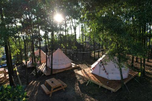 a group of tents sitting in the trees at Viewest Glamping Dong Mo in Hanoi