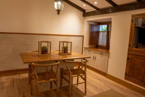 a kitchen with a wooden table and two chairs at Finca Pico in Los Realejos