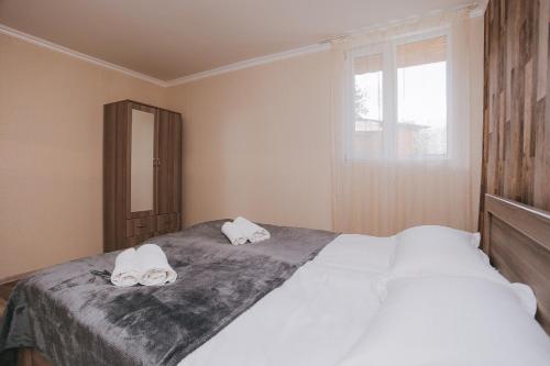 a bedroom with a bed with two towels on it at Mountain House Chirdili in Chirdili