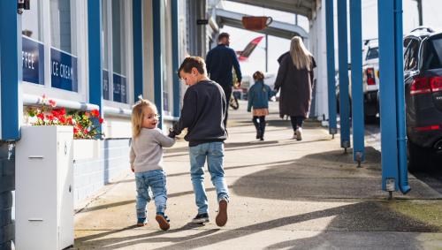a boy and a girl walking down a sidewalk at BIG4 Tassie Getaway Park Stanley in Stanley