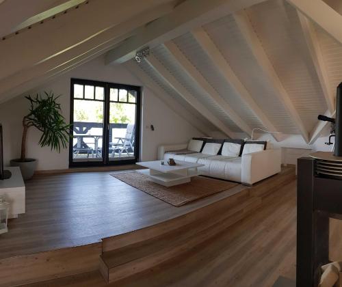 a living room with a white couch and a table at Ferienhaus Luise Urlaubslust Trassenheide in Trassenheide