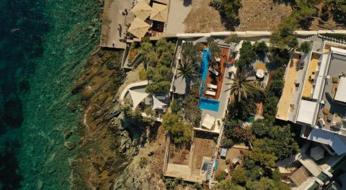 an aerial view of a resort next to the ocean at Pafsilipon Suites in Ermoupoli