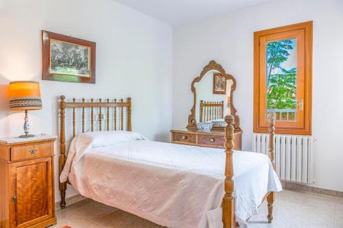a bedroom with a bed and a dresser and a mirror at Palma bay views 20m from the sea in Bellavista