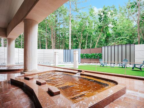 a large pool of water in a courtyard at Tokachi Nakasatsunai Glamping Resort Feriendorf in Naka-satsunai