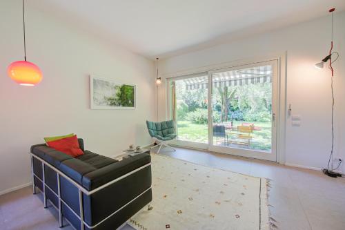 a living room with a couch and a chair at Casa Oliva Garden and Relax - Happy Rentals in Laveno