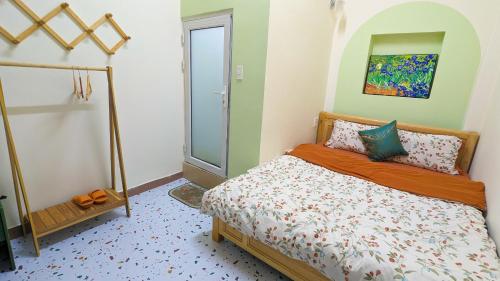 a bedroom with a bed and a glass door at Wasabi House 2 gần chợ đêm 5p đi bộ in Da Lat