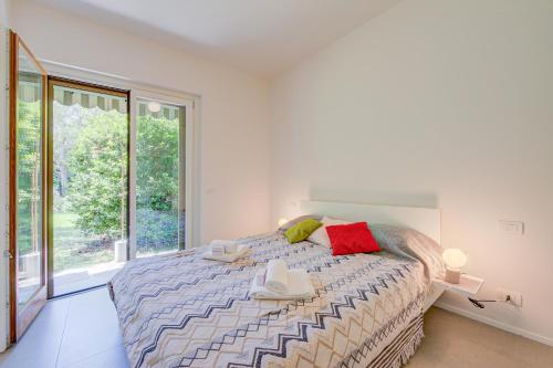 a bedroom with a bed and a large window at Casa Oliva Garden and Relax - Happy Rentals in Laveno