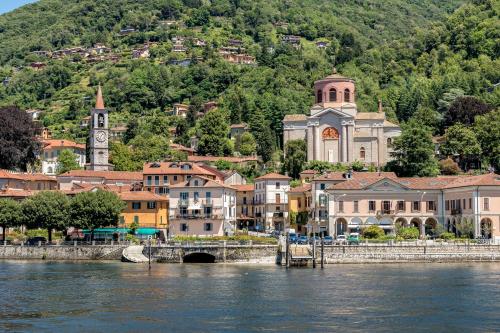a town next to a river with a bridge at Casa Oliva Garden and Relax - Happy Rentals in Laveno