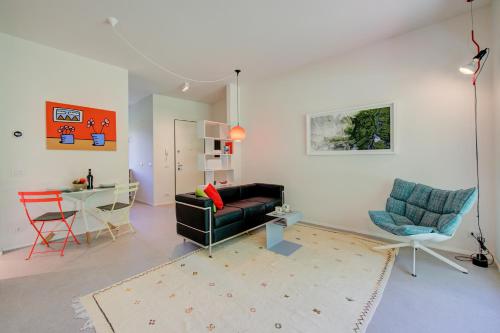 a living room with a couch and a table and chairs at Casa Oliva Garden and Relax - Happy Rentals in Laveno