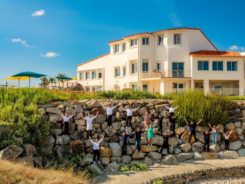 a group of people standing on a rock wall at La Villa Saint Jean in Les Sables-dʼOlonne
