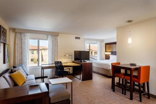 a hotel room with a bed and a living room at Residence Inn by Marriott Austin Lake Austin/River Place in Four Points