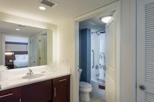 a bathroom with a sink and a toilet and a mirror at Residence Inn by Marriott Austin Lake Austin/River Place in Four Points