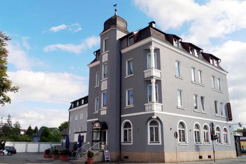 a large white building with a tower on top at Hotel Grader in Neustadt an der Waldnaab