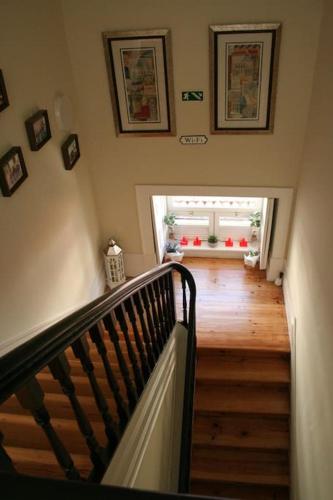 a staircase leading up to a room with a window at sky accommodations Barcelona Studio in Coimbra