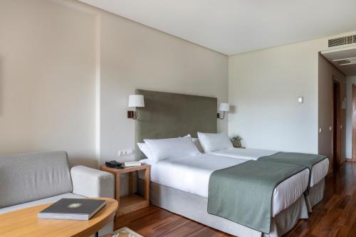 a hotel room with a bed and a chair at Parador de Ronda in Ronda