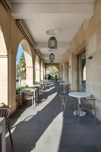 a hallway with tables and chairs in a building at Parador de Ronda in Ronda