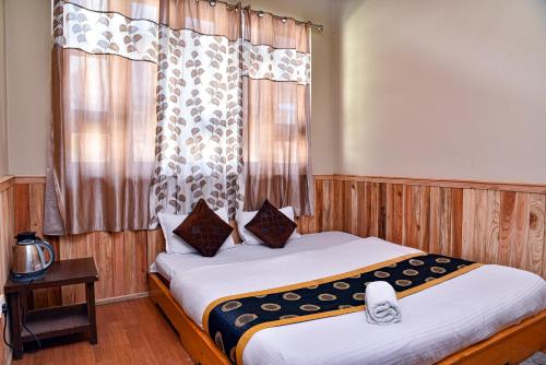 a bedroom with a bed and a window at Rufina Lachung Deezong in Lachung