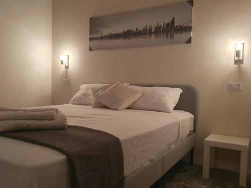 a bedroom with a bed with a picture on the wall at Living Room Orlando in Corigliano Calabro