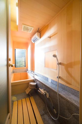 a bathroom with a shower and a tub and a sink at 高野山 宿坊 総持院 -Koyasan Shukubo Sojiin- in Koyasan