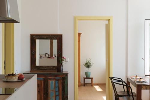 a kitchen with a mirror and a table at Goldener Löwe in Bodman-Ludwigshafen