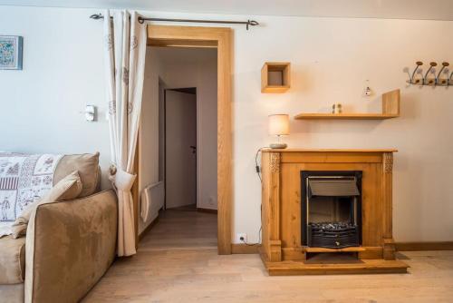 un salon avec une cheminée et un canapé dans l'établissement IMMODREAMS - Le Refuge, à Morzine