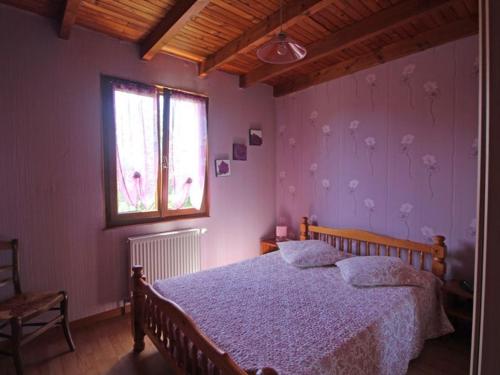 a bedroom with a bed and a window at Gîte nature, 15 km de Gérardmer, randonnée, ski, jardin, terrasse, BBQ, équipements bébé inclus - FR-1-589-64 in Champdray
