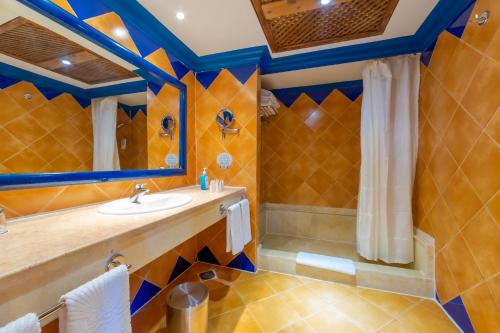 a bathroom with a sink and a shower at Grand Makadi - Couples and Families Only in Hurghada