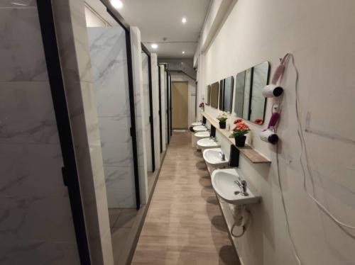 a bathroom with a row of sinks and mirrors at BEAT Arts Hostel at Chinatown in Singapore