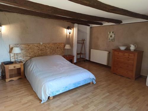 a bedroom with a white bed and a wooden floor at Gîte Nonville, 3 pièces, 6 personnes - FR-1-589-427 in Nonville
