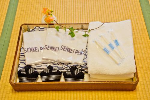 a suitcase filled with towels and napkins on a table at Senkei Plaza in Hakone