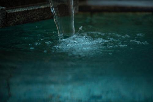 a close up of water pouring into a pool of water at Senkei Plaza in Hakone