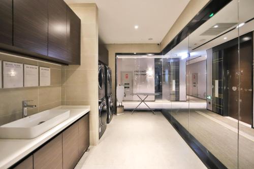 a bathroom with a sink and a mirror at Atour X Hotel Changchun Railway Station in Changchun