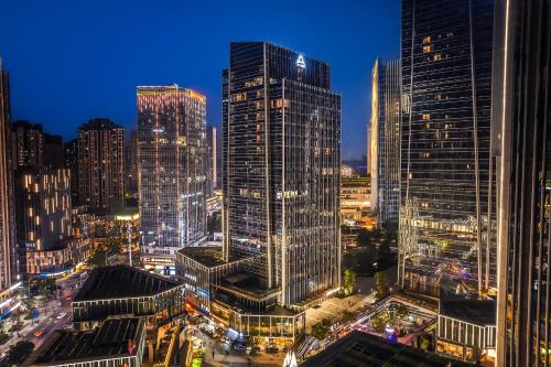 a night view of a city with tall buildings at Atour Hotel Chongqing Liangjiang District Jinke Center in Chongqing