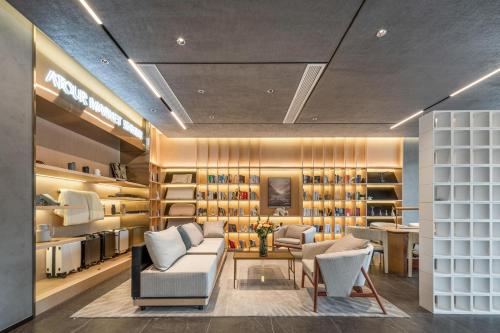 a room with couches and chairs in a store at Atour Hotel Yuyao Nanlei Building in Ningbo