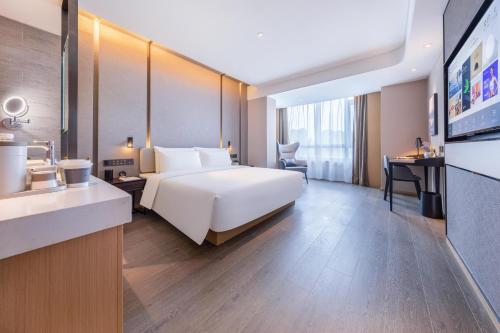Ένα ή περισσότερα κρεβάτια σε δωμάτιο στο Atour Hotel Xuzhou Pei County Dongfeng Road