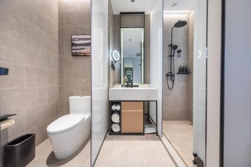 a bathroom with a toilet and a sink and a shower at Atour X Hotel Shenyang Beiling Park in Shenyang