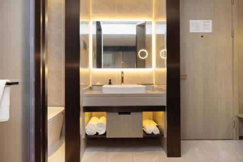 a bathroom with a sink and a mirror at Atour X Hotel Shanghai Hongqiao National Exhibition Qibao Old Street in Shanghai