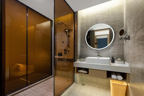 a bathroom with a sink and a mirror at Atour Hotel Kunshan Chengdong Development Zone in Kunshan