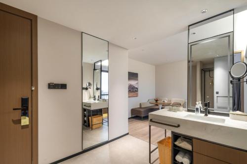 a bathroom with a sink and a mirror at Atour Hotel Nantong Longxin Plaza in Nantong